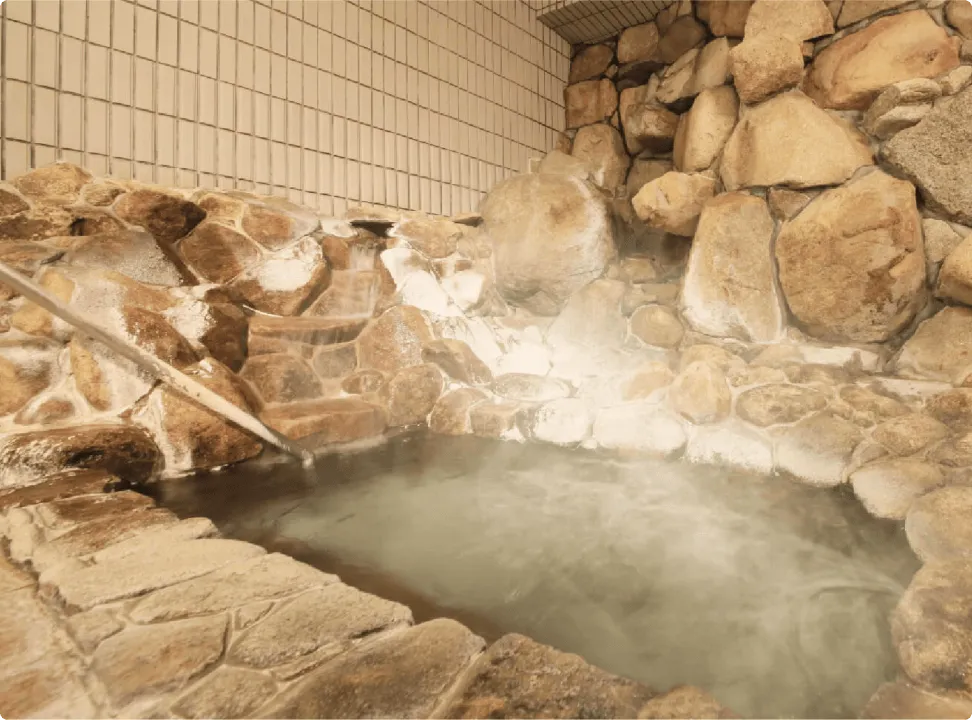 녹음에 둘러싸인 정원 안에서 분위기가 다른 여러 욕조를 즐길 수 있는 지붕이 있는 노천탕